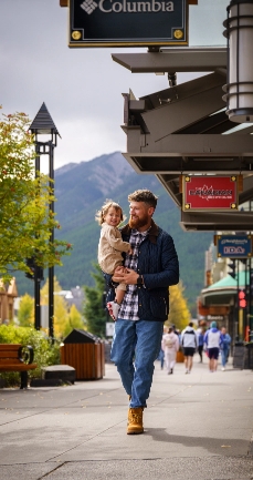 Man Walking with Daughter Outside Banff Shopping Centre